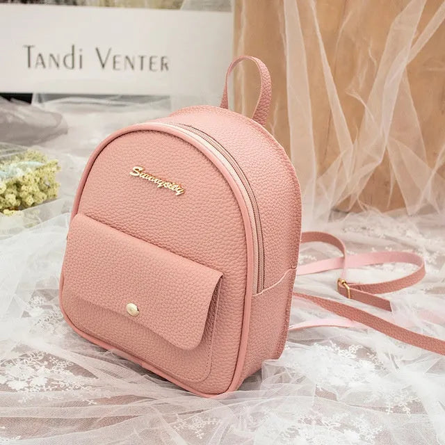 Compact black PU women's shoulder bag also worn as a small backpack, showing zipper closure.