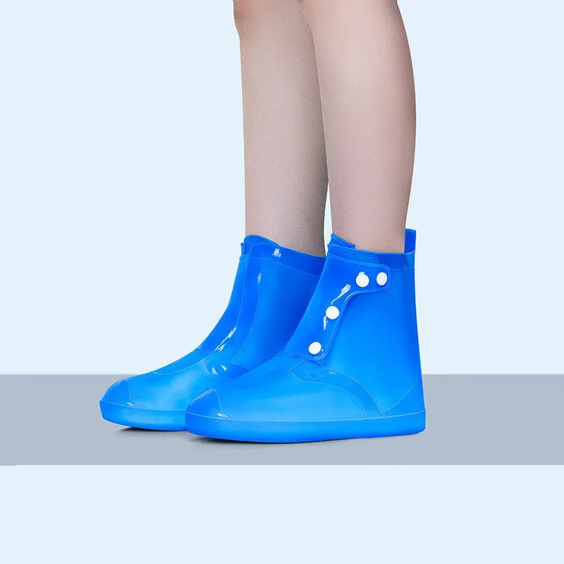 White PVC high top reusable shoe covers for women, shown on a foot, for water resistant protection.