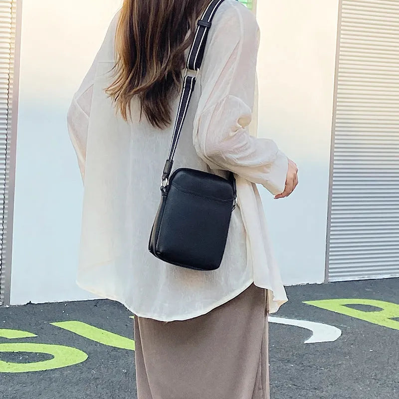 Small solid colour mobile phone crossbody bag in PU leather measuring 14.5cm wide