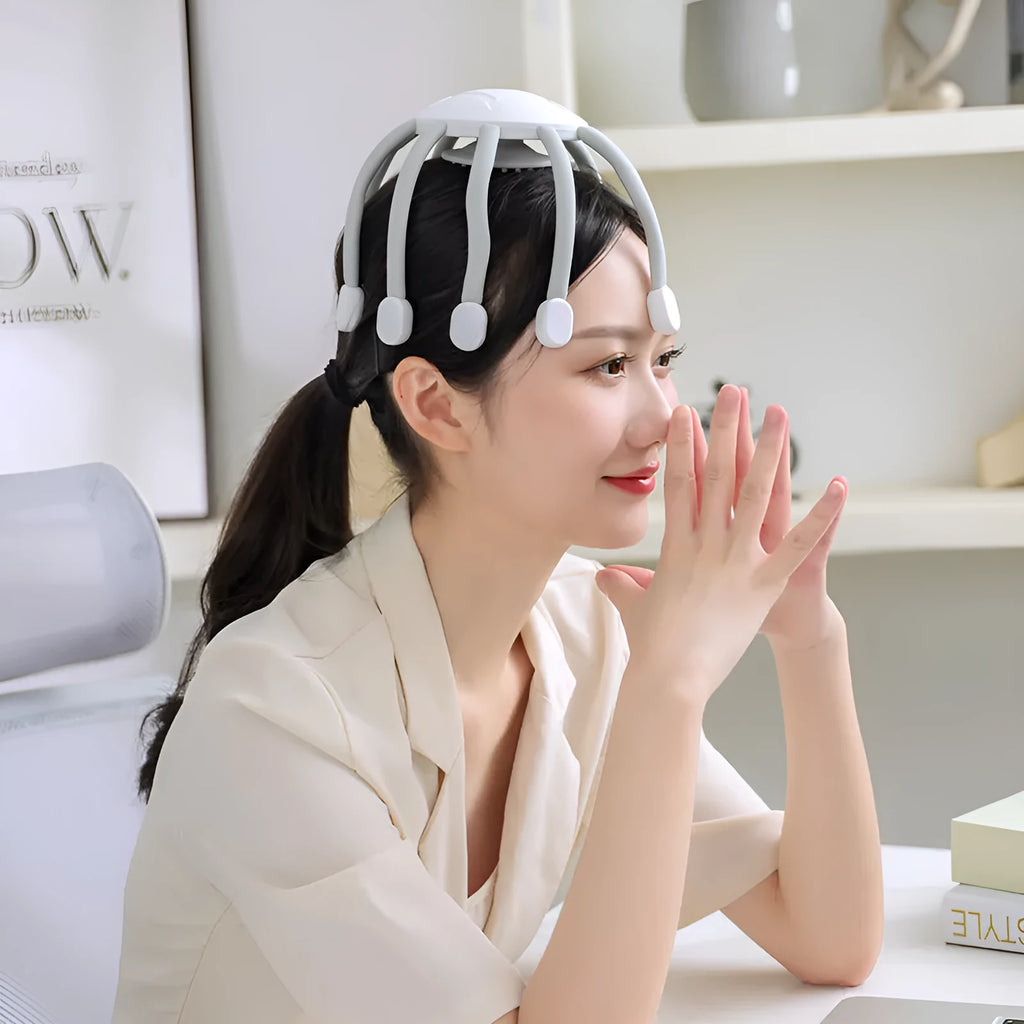 Black USB-powered head massager with multiple claws placed on a scalp