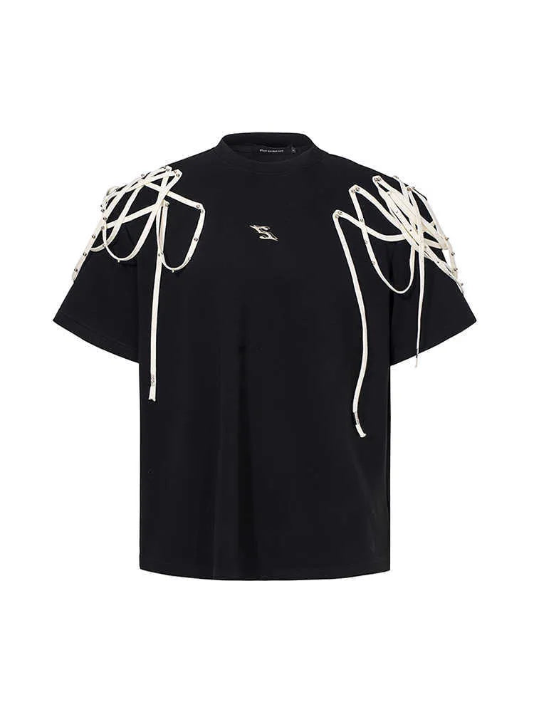 Black loose fit short sleeve T-shirt with ribbon and rivet decorated padded shoulders.