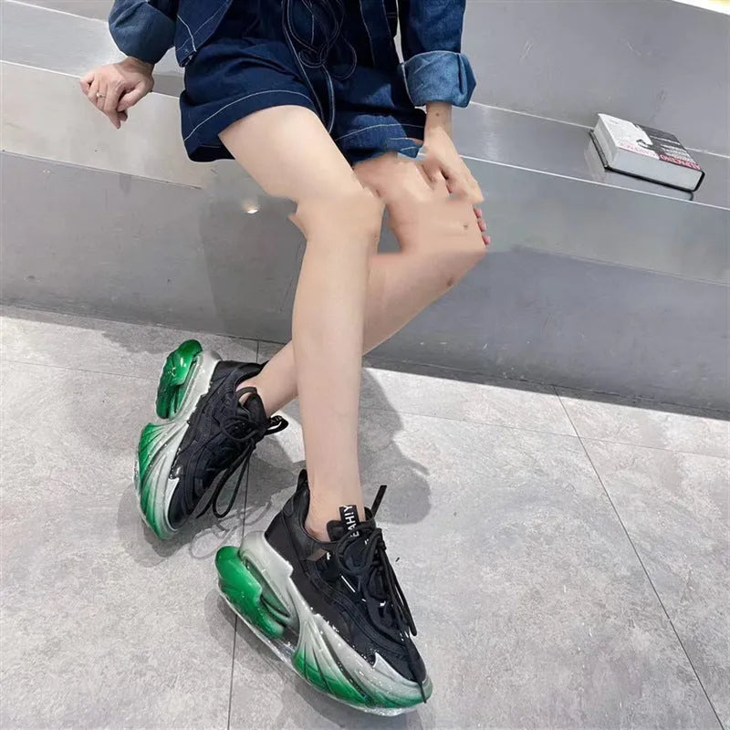 Women's green leather sports shoes with thick soles and cross-tie lacing on a white background.