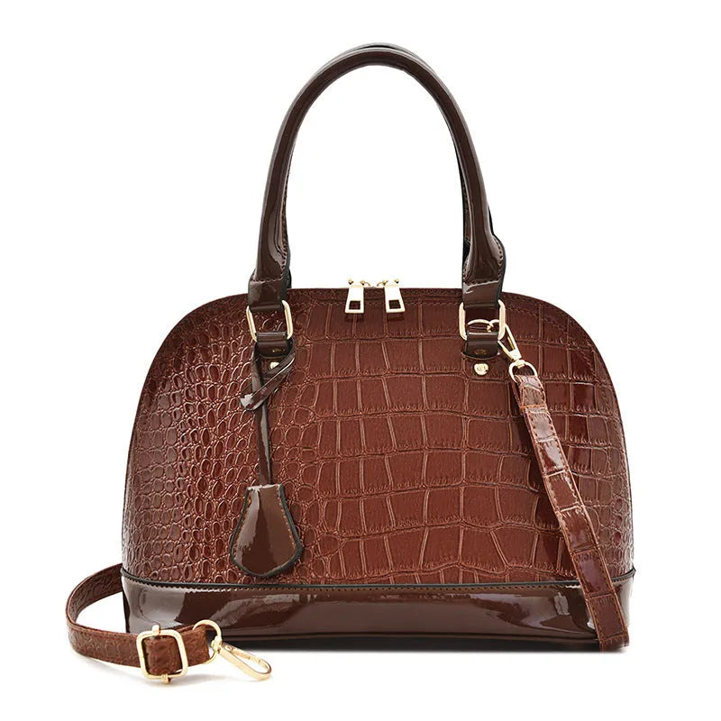 Shiny PU leather crossbody shoulder bag in structured shell shape design showing black colour option