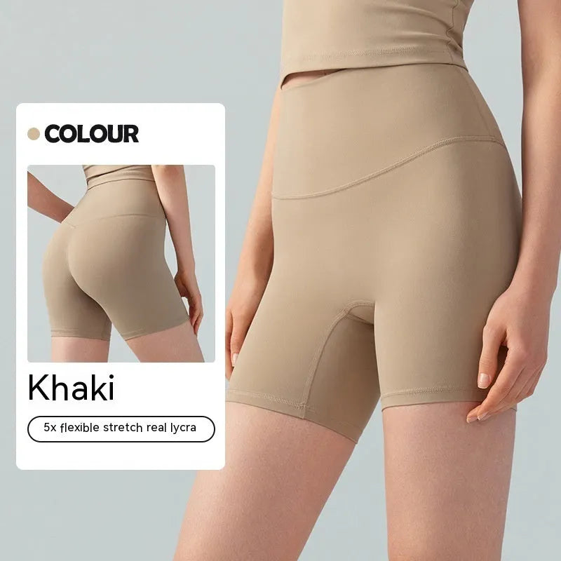 Women's high waist Lycra yoga shorts in leaf green, shown in a yoga pose.