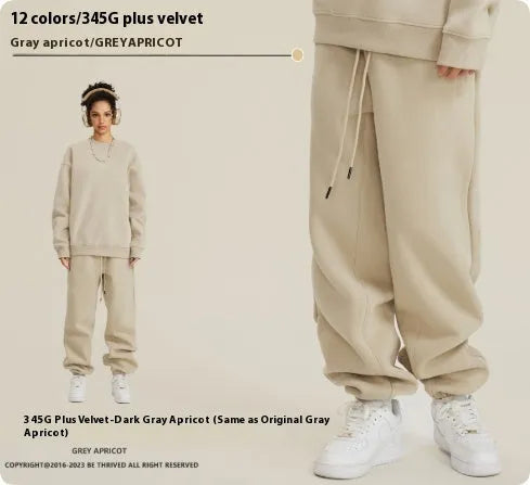 Men's dark brown velvet sweatpants with elastic waistband and banded ankle cuffs on hanger