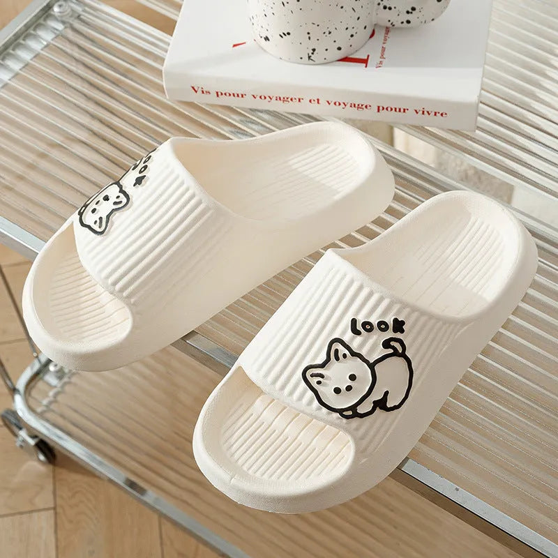 Green EVA platform flip flop slippers with a raised cat design on the upper.