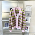 Pink haima wool lazy coat cardigan sweater with nap texture on a hanger