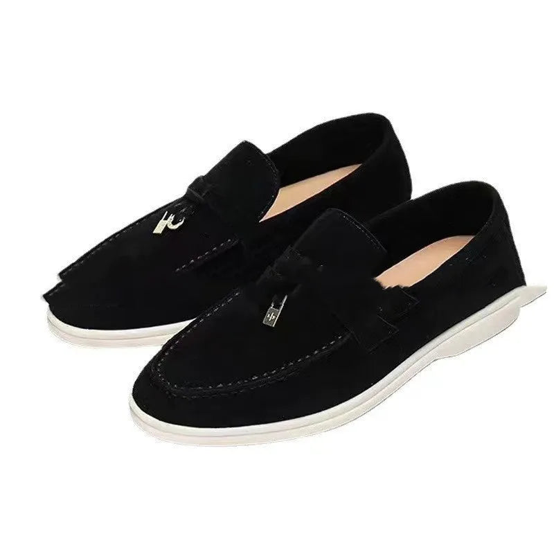 Unisex high-top slip-on loafers with a round toe cap and rubber sole on a neutral background.