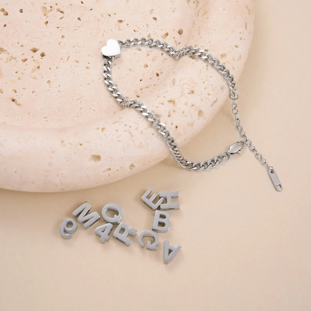 Gold or silver titanium steel necklace with a personalised letter, number, or heart pendant on a 40.5cm chain.