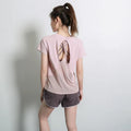 Women's short sleeve polyester sports t-shirt in pink, shown flat.