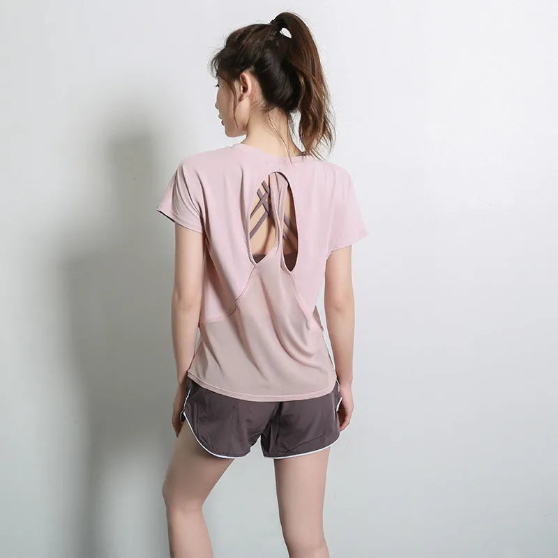 Women's short sleeve polyester sports t-shirt in pink, shown flat.