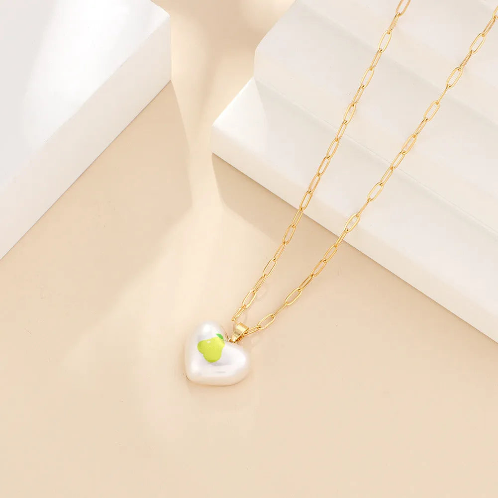 Adjustable girls necklace with a choice of apple, cherry, pear, pineapple, or strawberry heart-shaped pendant.