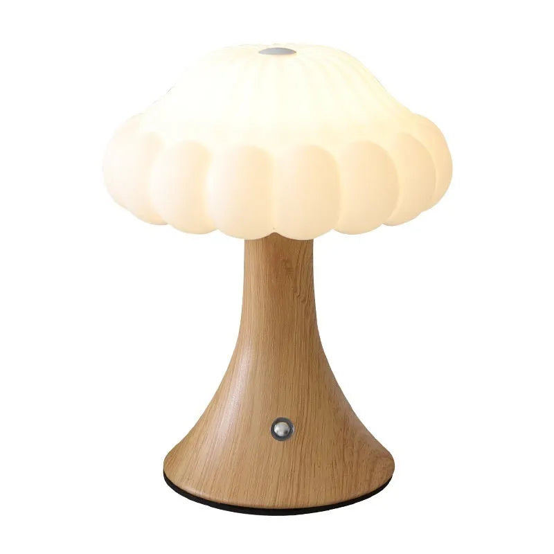 Small mushroom-shaped touch control night light in wood grain finish on a wooden table