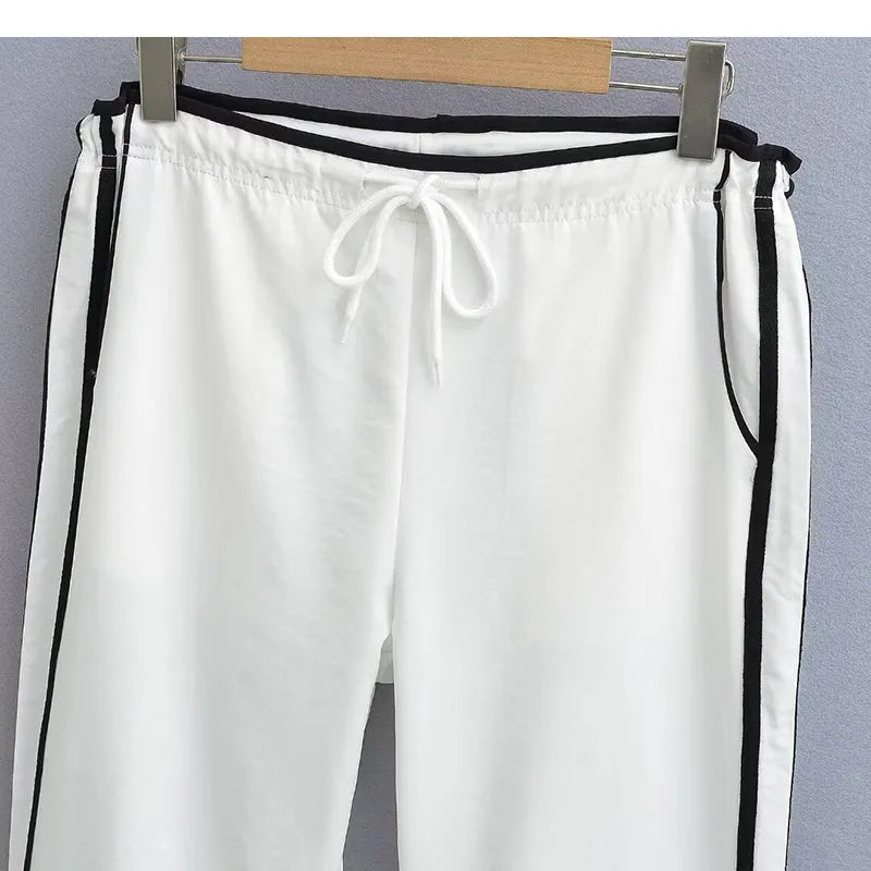 Women's navy blue loose straight leg trousers with ribbon parallel bars detail on the leg.