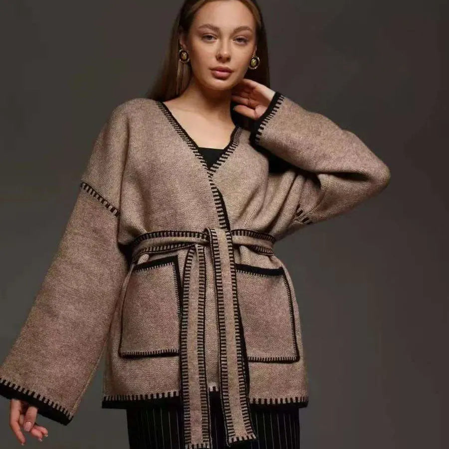 Lace-up front knitted cardigan in camel colour showing loose mid-length design and long sleeves