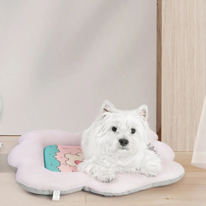 Green pet cooling mat for a medium-sized dog lying on a floor.