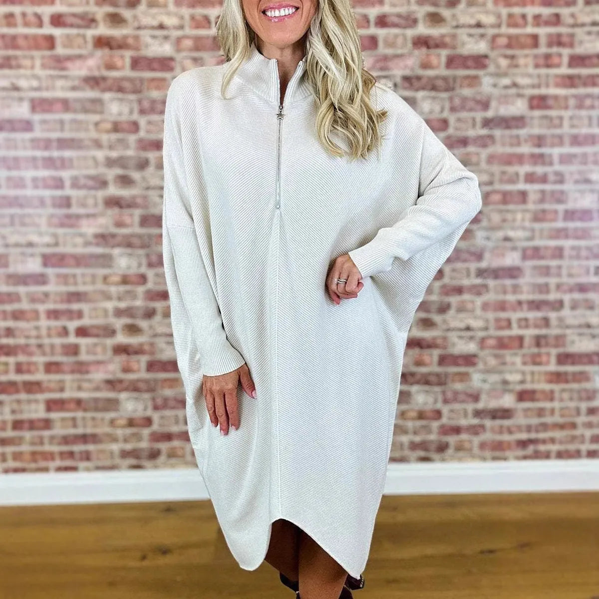 Women's solid colour loose knitted dress with raglan sleeves, shown in dark green.