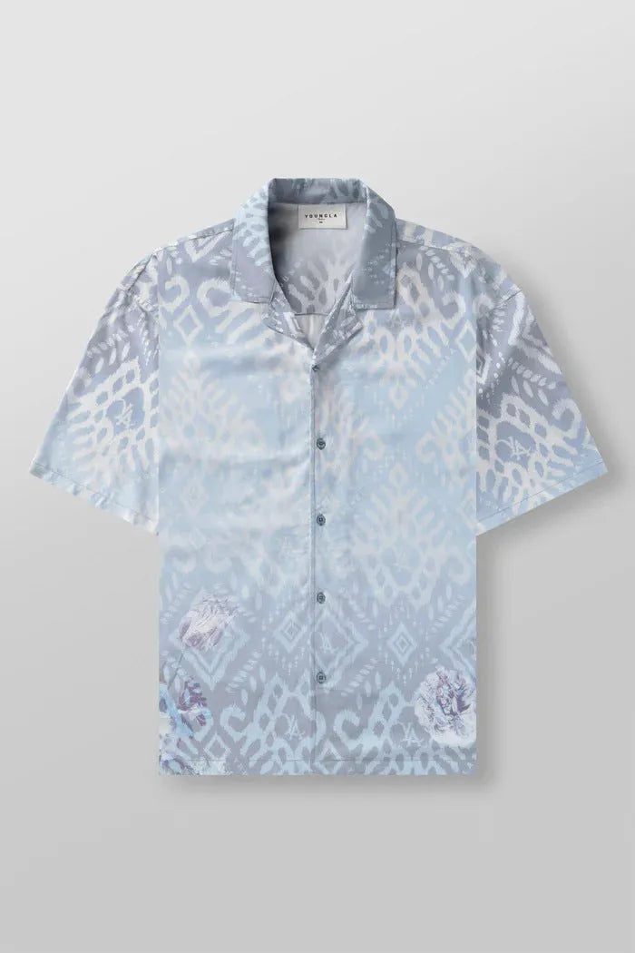 Man wearing a loose grey short sleeve cardigan top with a white floral print pattern.