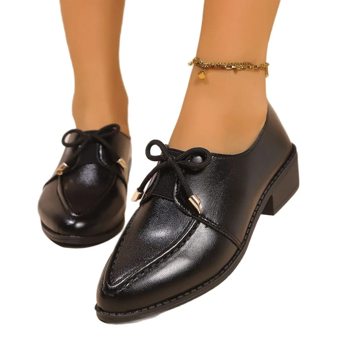 Women's British-style leather shoes with a decorative bow, rubber sole, and pointed toe.