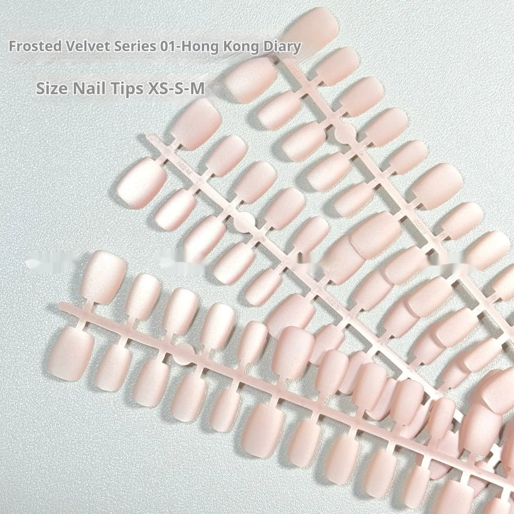 Set of frosted velvet Cat's Eye false nail wraps in short ladder sizes XS, S, and M on a display stand.