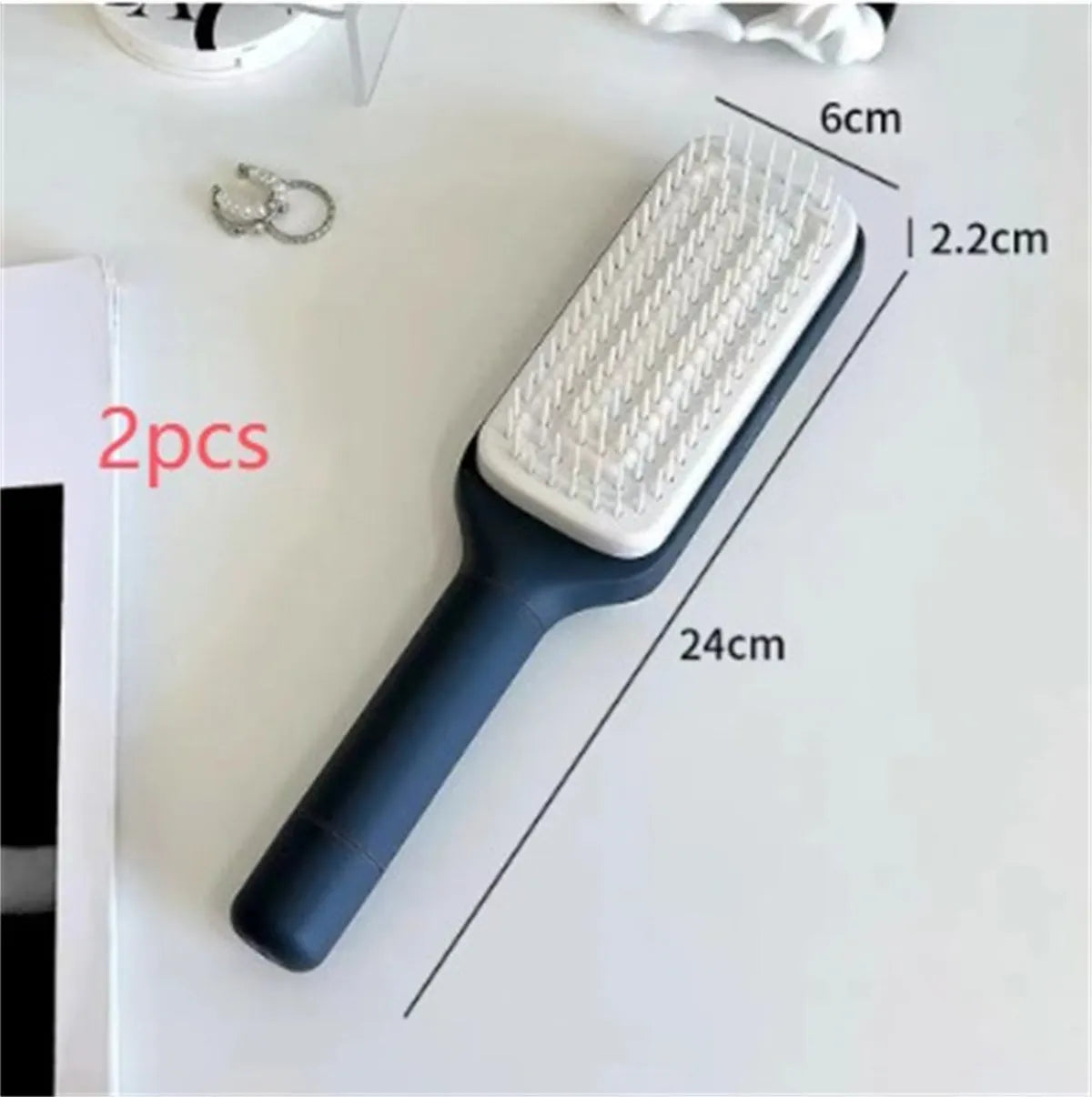 Roland purple and lunar rock grey self-cleaning hair brush with anti-static massage comb teeth.