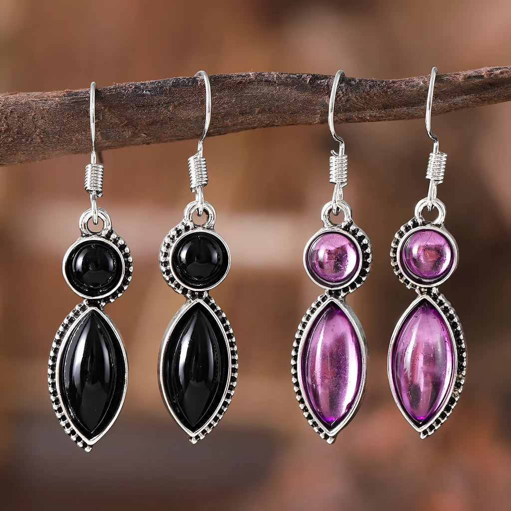 A pair of black and purple vintage geometric pendant earrings with bohemian style on a white background.