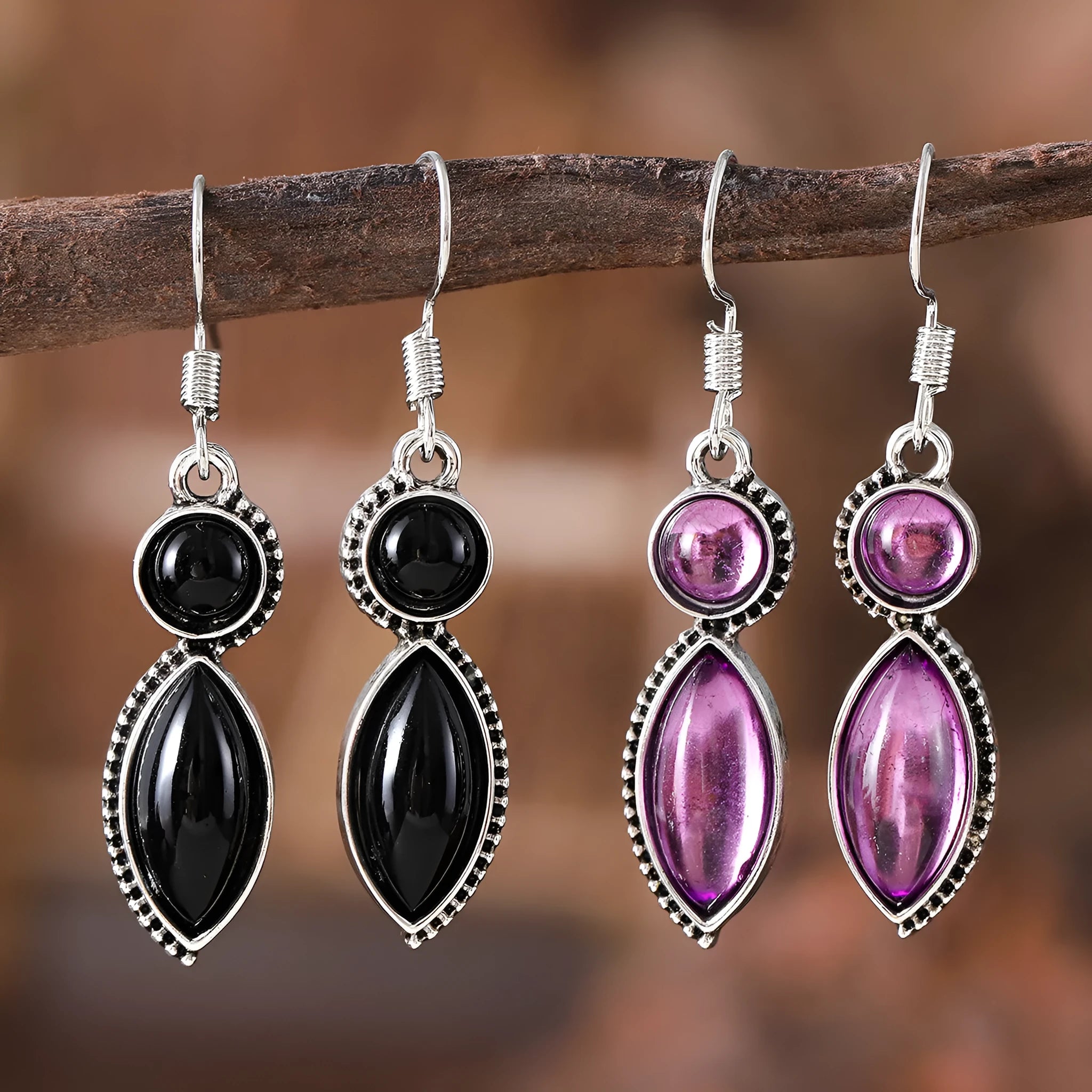 A pair of black and purple vintage geometric pendant earrings with bohemian style on a white background.