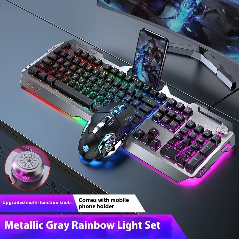 Aluminium gaming keyboard with volume knob, shown in metal grey with RGB lighting alongside optional macro mouse and headset.