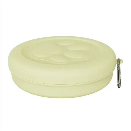 Portable outdoor dog food and water bowl with attached snack box in light pink and green colours.