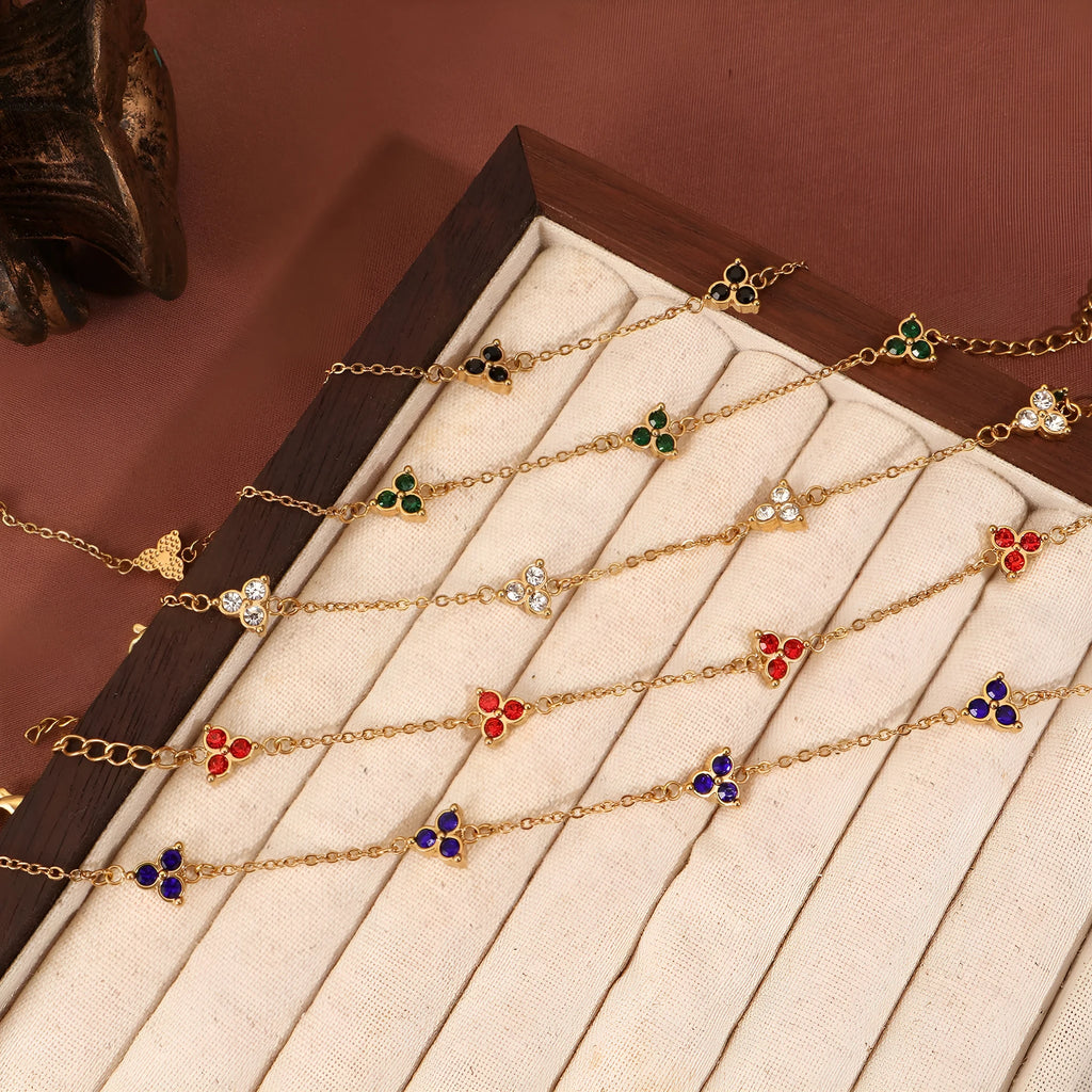 Stainless steel women's bracelet with three triangular diamond motifs set with colourful zircon stones.