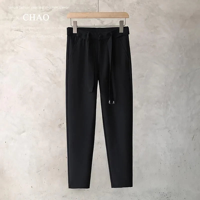 Boys slim straight tapered wool trousers in light grey on a hanger, showing the straight leg opening and business casual style.