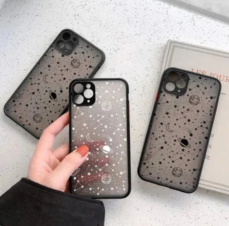 Black anti-blue-light soft-touch iPhone case for multiple models on a table.