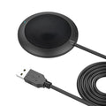 Black circular USB conference microphone with metal mesh grill on a desk