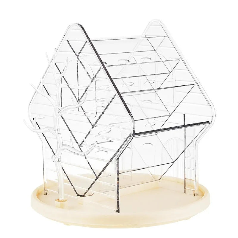 Rotating multi-tiered cosmetics storage box in clear transparent plastic on a wooden surface.