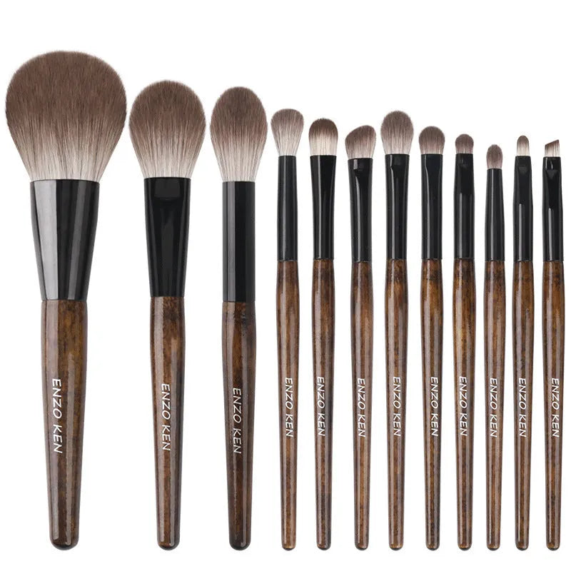 12-piece makeup brush set with wooden handles and a grey PU travel bag