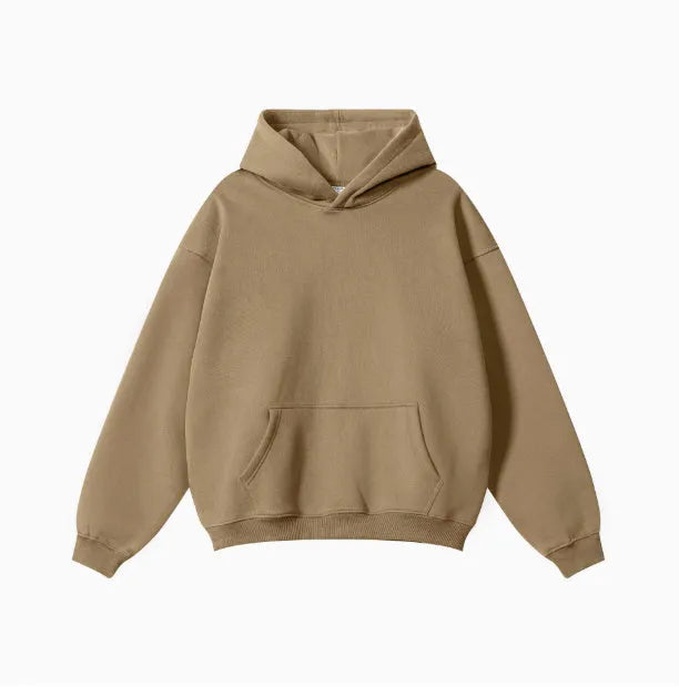 Man wearing a loose-fit cotton terry hooded sweater with drop-shoulder sleeves in a solid colour.