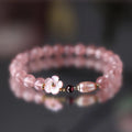 Strawberry quartz peach blossom crystal bracelet with flower-shaped beads on elastic cord