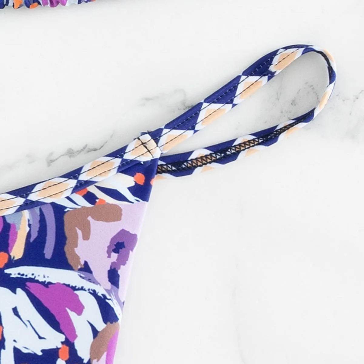 Women's floral printed polyester swimsuit with triangle bag design and briefs style bottom in S, M, L sizes
