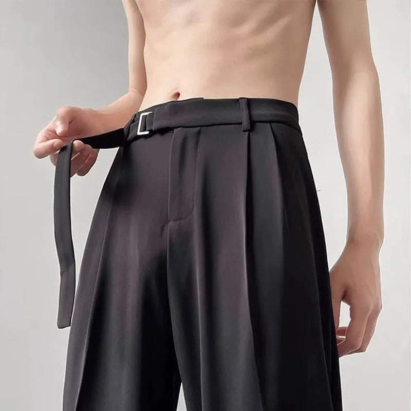 Black wide leg straight trousers with a loose casual fit on a hanger.