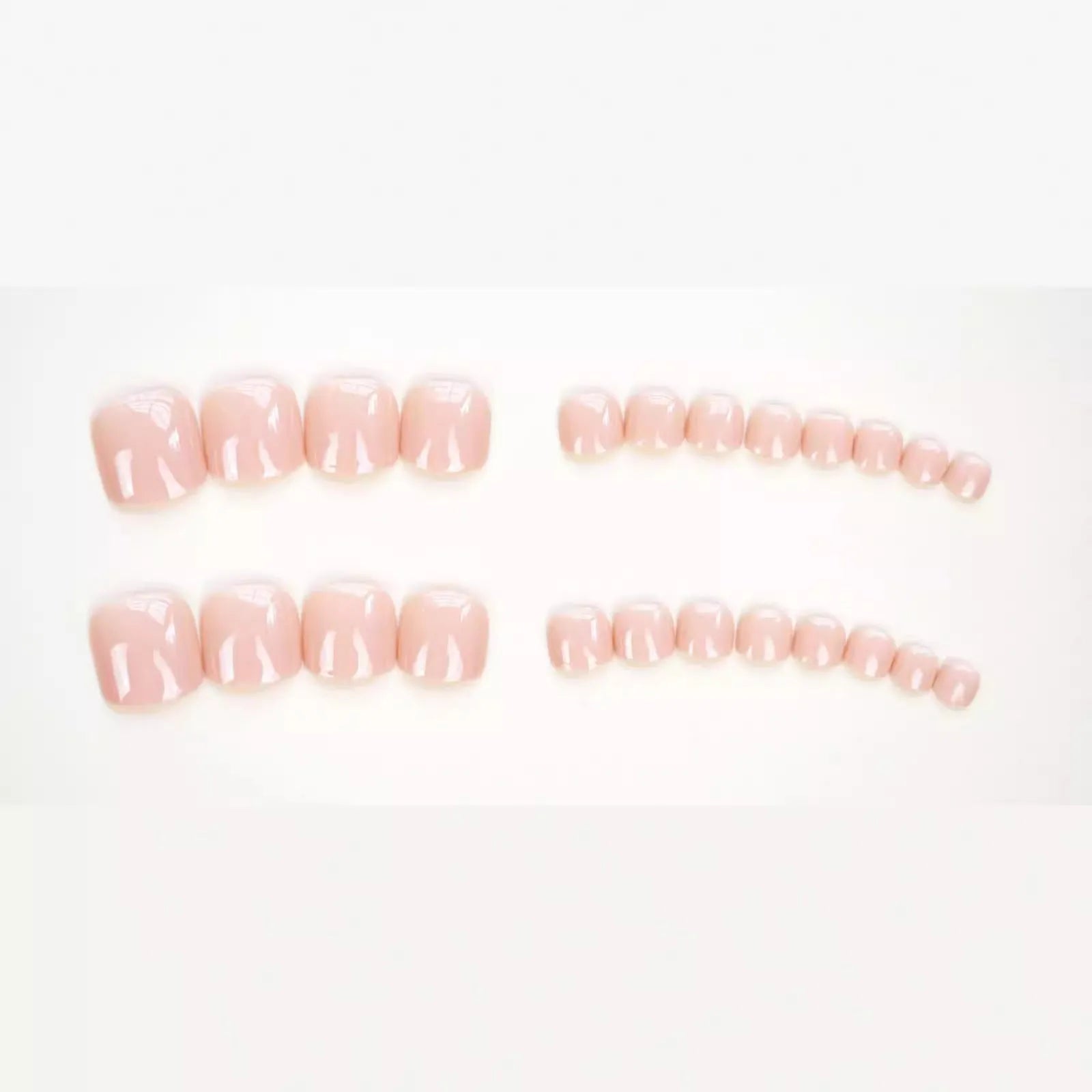 Pack of finished skin colour false toenails and a tube of adhesive glue for nail art.