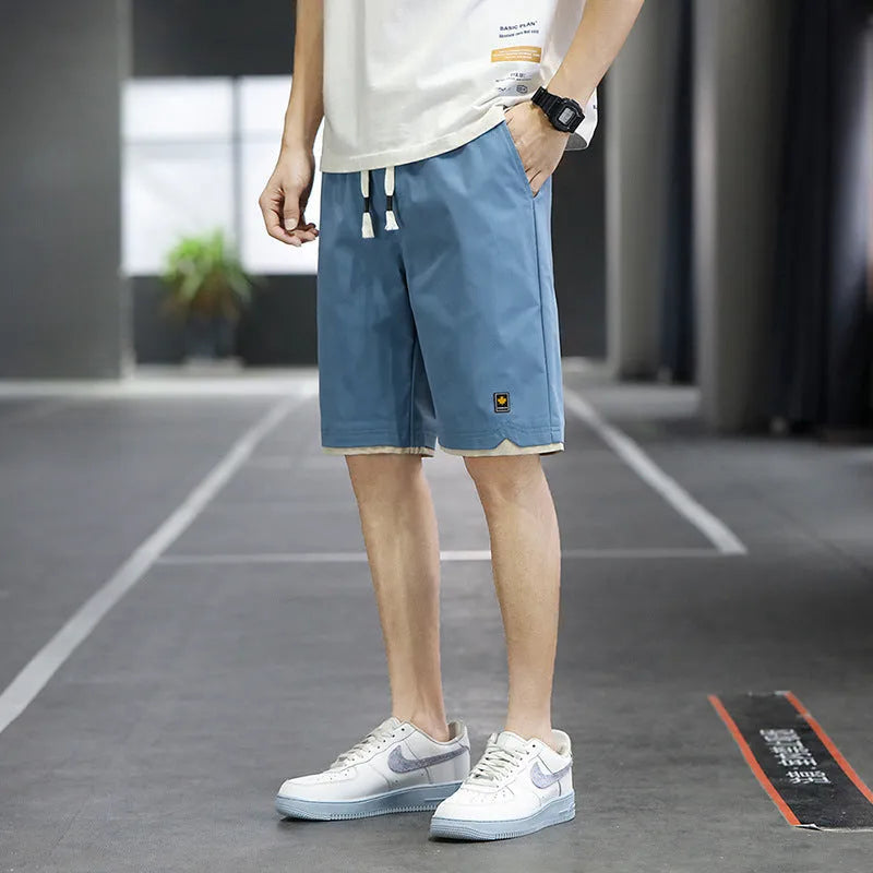 Men's loose-fit straight-leg casual beach shorts in polyester, shown in 8905 Green colour.