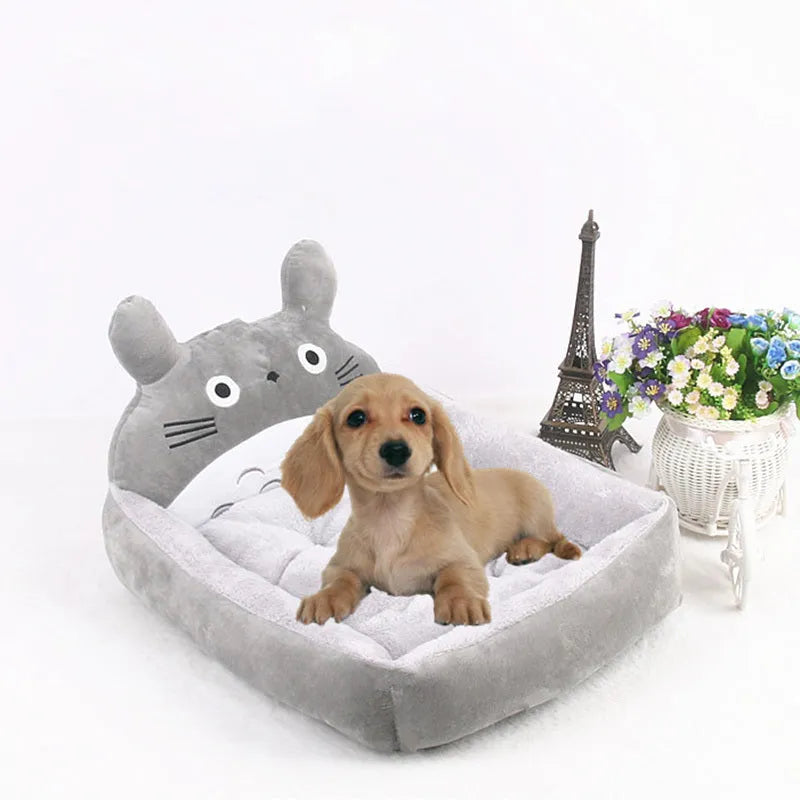 A cartoon-style washable pet sofa bed for small dogs and cats, shown in blue, brown, gray, or pink.