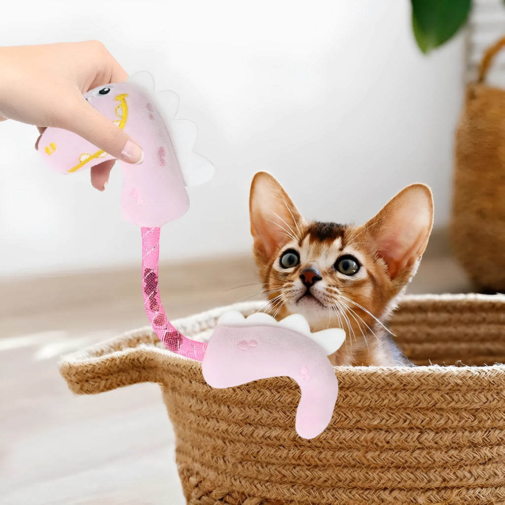Set of four cat toys: plush fish, mouse, bunny, and a catnip rope on a pink background.