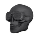 Skull-shaped wireless Bluetooth speaker showing front view with controls and available colour options
