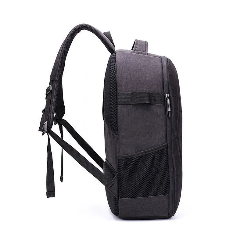 Large black Oxford fabric drone backpack showing multiple internal organiser pockets for laptop and camera.