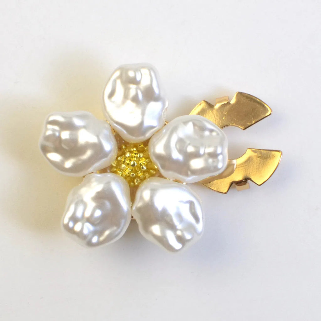 White alloy pearl rhinestone cufflink with electroplated finish and inlaid diamond setting on solid background