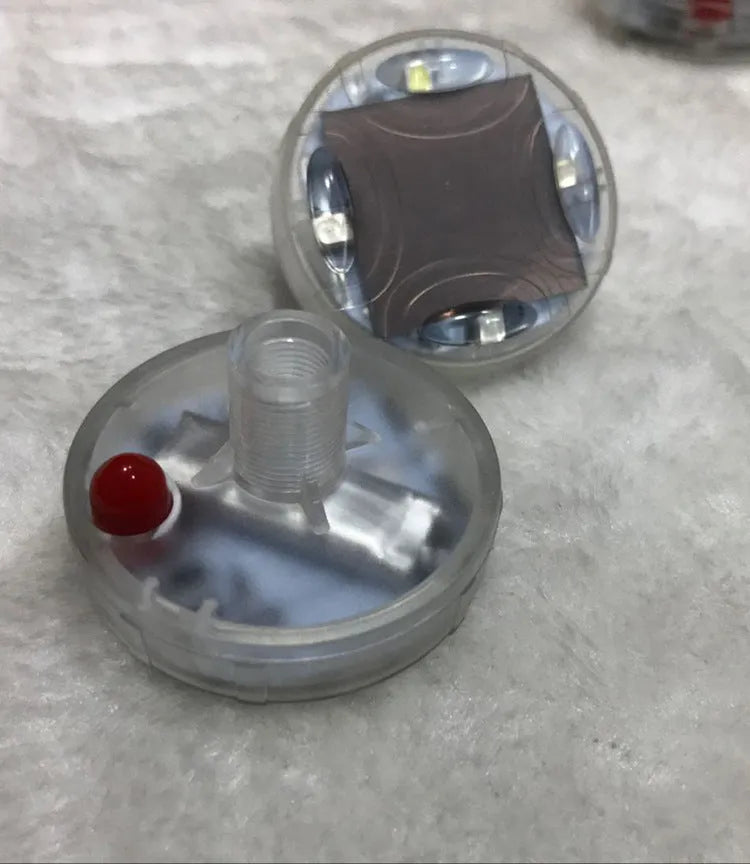 Colourful solar-powered LED valve light for mounting on vehicle wheel hubs.