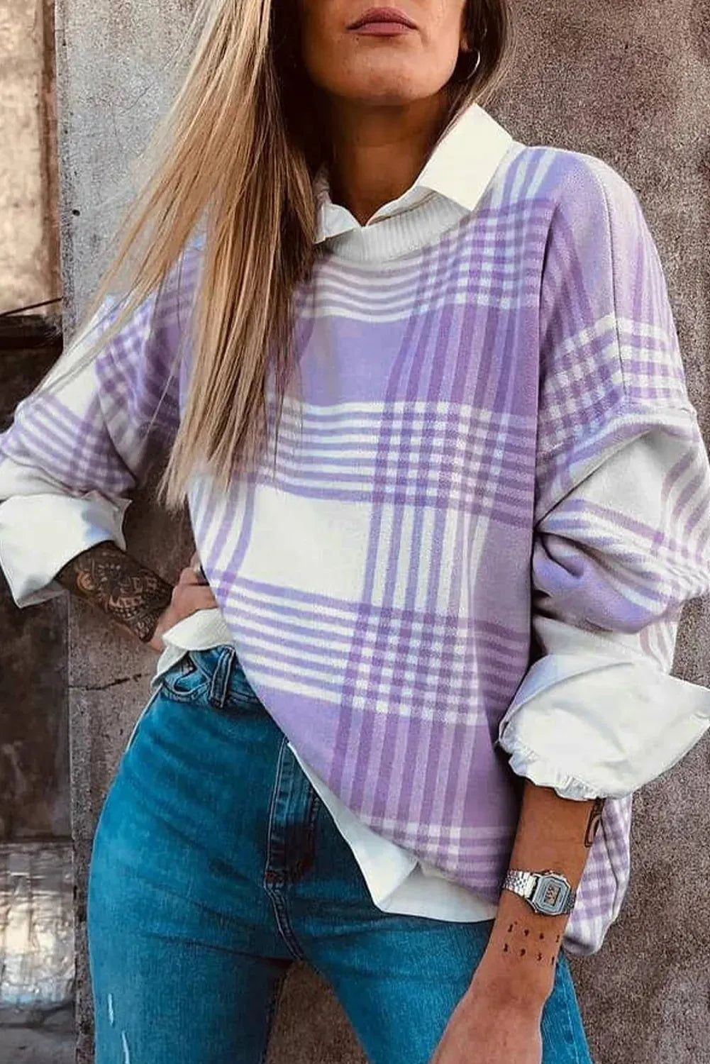Lilac plaid print loose fit long sleeve sweater with ribbed trim on a hanger.