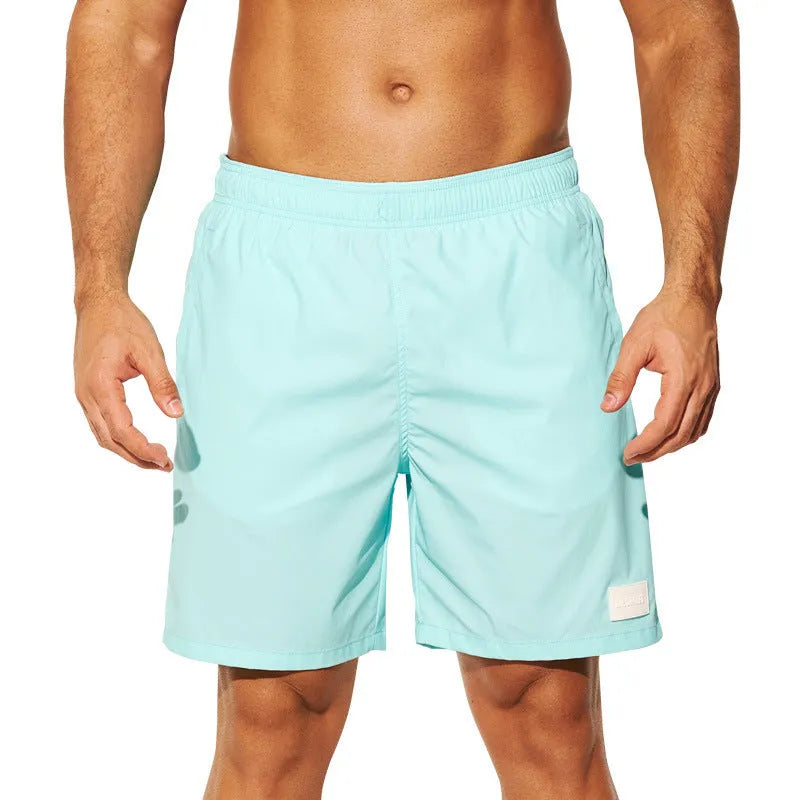 Men's quick-drying nylon sports shorts in green, shown with straight leg and elastic waist.