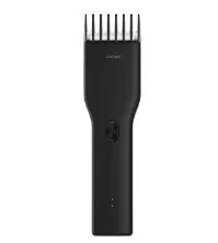 Black cordless electric hair clippers with a ceramic cutter head and a white adjustable length comb attached.